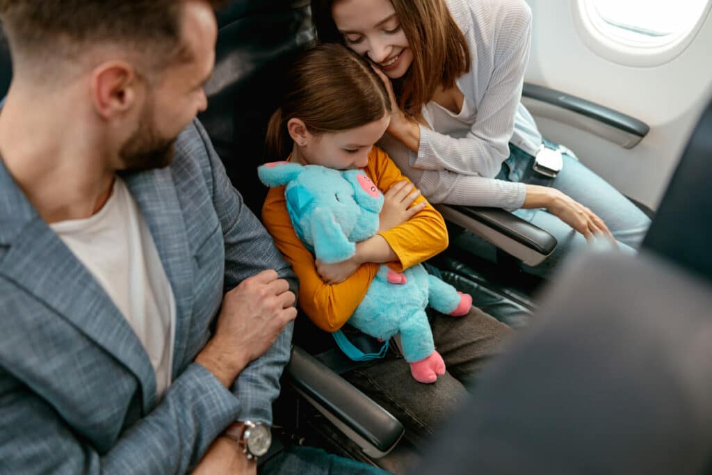 cheerful woman traveling with family by airplane 2025 03 25 05 17 15 utc(1)