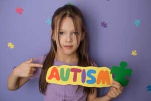 young girl holding sign in front of backdrop 2026 03 05 11 49 46 utc(1)